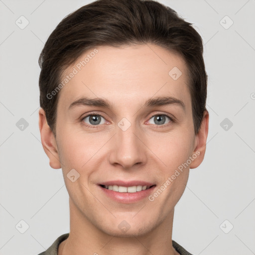 Joyful white young-adult male with short  brown hair and grey eyes