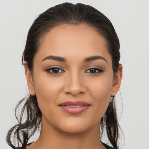 Joyful latino young-adult female with long  brown hair and brown eyes