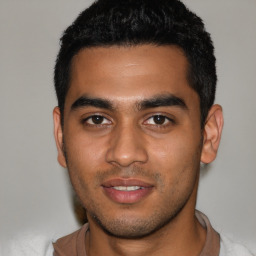 Joyful latino young-adult male with short  brown hair and brown eyes