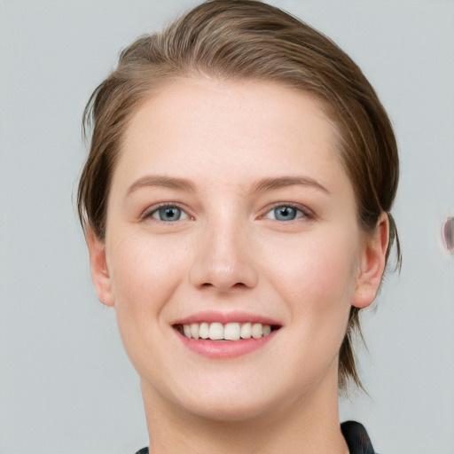 Joyful white young-adult female with medium  brown hair and grey eyes