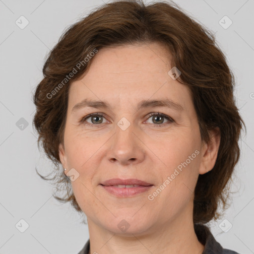 Joyful white adult female with medium  brown hair and grey eyes