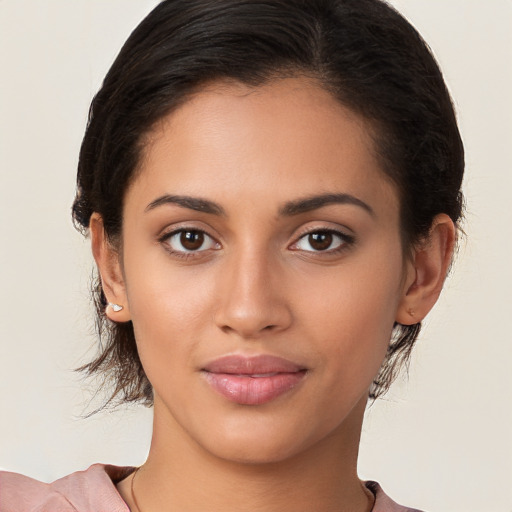 Joyful latino young-adult female with medium  brown hair and brown eyes