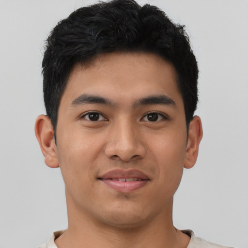 Joyful asian young-adult male with short  black hair and brown eyes