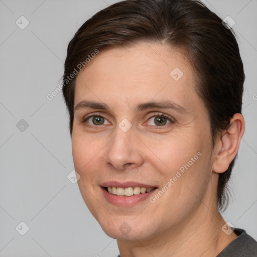 Joyful white adult female with medium  brown hair and brown eyes