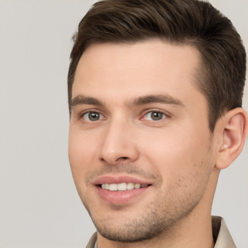 Joyful white young-adult male with short  brown hair and brown eyes