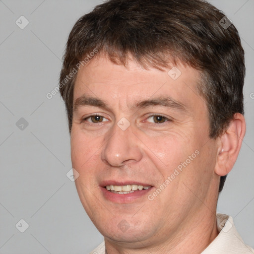 Joyful white adult male with short  brown hair and brown eyes