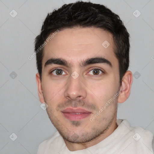 Joyful white young-adult male with short  black hair and brown eyes