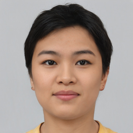 Joyful asian young-adult female with short  black hair and brown eyes