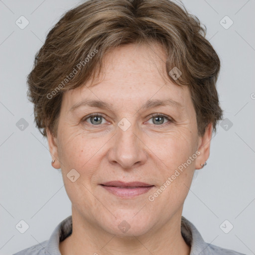 Joyful white adult female with short  brown hair and grey eyes