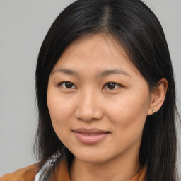 Joyful asian young-adult female with long  brown hair and brown eyes