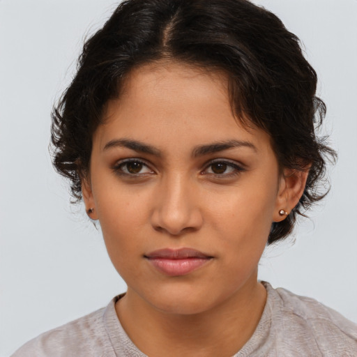 Joyful latino young-adult female with medium  brown hair and brown eyes