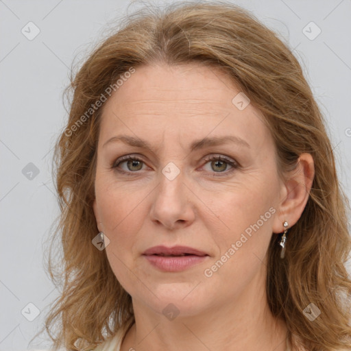 Joyful white adult female with long  brown hair and grey eyes