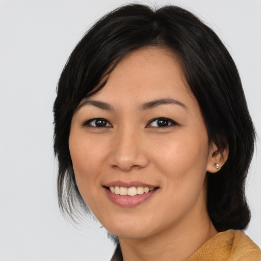 Joyful asian young-adult female with medium  black hair and brown eyes