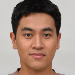 Joyful asian young-adult male with short  black hair and brown eyes