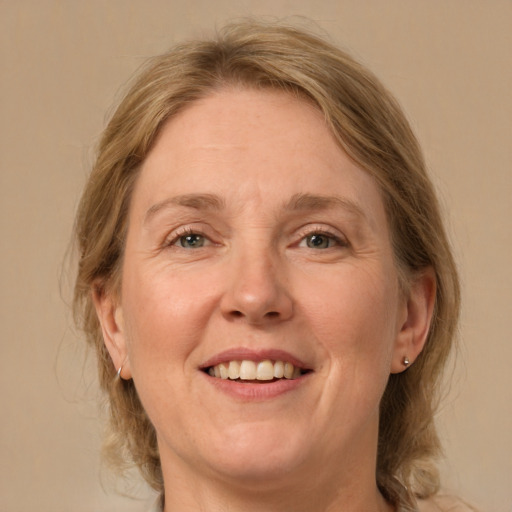 Joyful white adult female with medium  brown hair and grey eyes