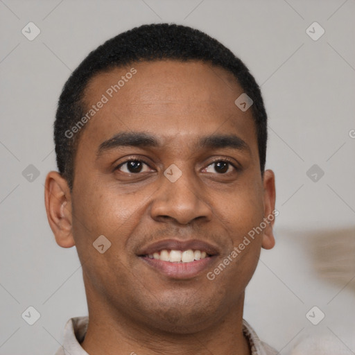 Joyful black young-adult male with short  brown hair and brown eyes