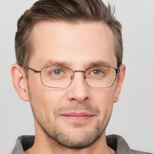 Joyful white adult male with short  brown hair and grey eyes