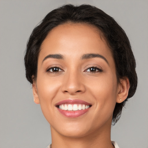 Joyful latino young-adult female with medium  black hair and brown eyes