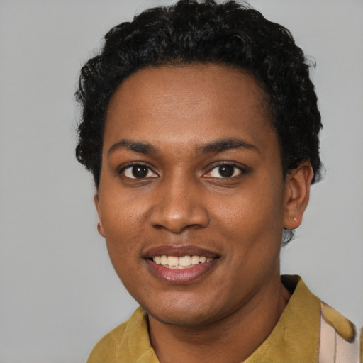Joyful black young-adult female with short  black hair and brown eyes