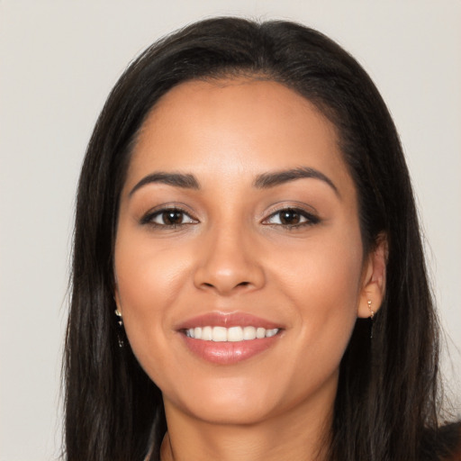 Joyful latino young-adult female with long  brown hair and brown eyes