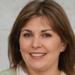 Joyful white adult female with medium  brown hair and brown eyes