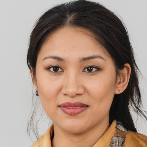 Joyful latino young-adult female with medium  brown hair and brown eyes