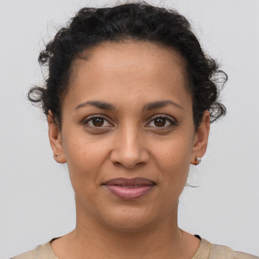 Joyful latino young-adult female with short  brown hair and brown eyes