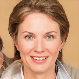 Joyful white adult female with medium  brown hair and grey eyes