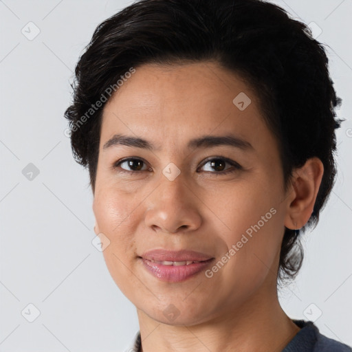 Joyful latino young-adult female with medium  brown hair and brown eyes