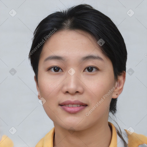 Joyful asian young-adult female with short  brown hair and brown eyes