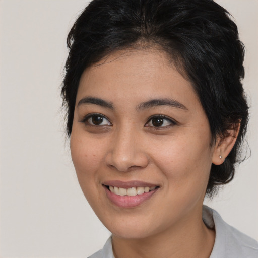 Joyful asian young-adult female with medium  brown hair and brown eyes