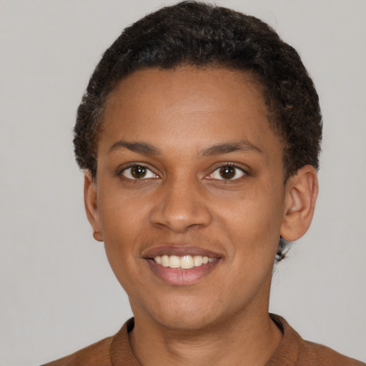 Joyful black young-adult female with short  brown hair and brown eyes