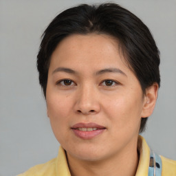 Joyful asian adult female with medium  brown hair and brown eyes