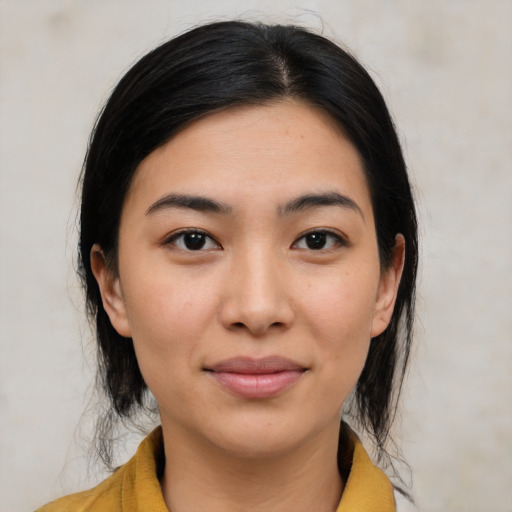 Joyful latino young-adult female with medium  black hair and brown eyes