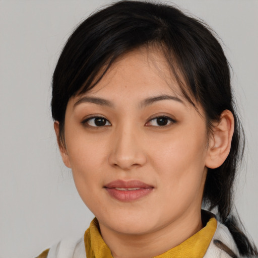 Joyful asian young-adult female with medium  brown hair and brown eyes