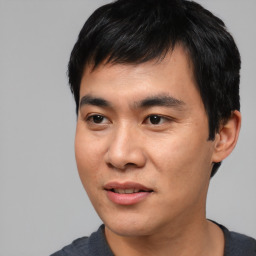 Joyful asian young-adult male with short  black hair and brown eyes