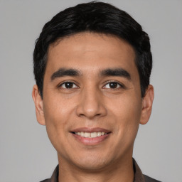 Joyful white young-adult male with short  black hair and brown eyes