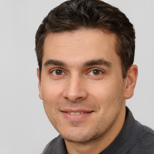 Joyful white young-adult male with short  brown hair and brown eyes