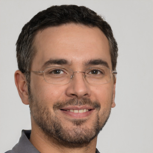 Joyful white adult male with short  brown hair and brown eyes