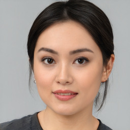 Joyful asian young-adult female with medium  black hair and brown eyes