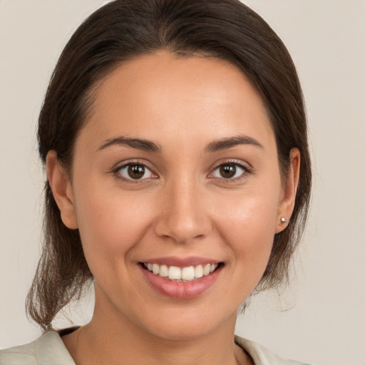 Joyful white young-adult female with medium  brown hair and brown eyes