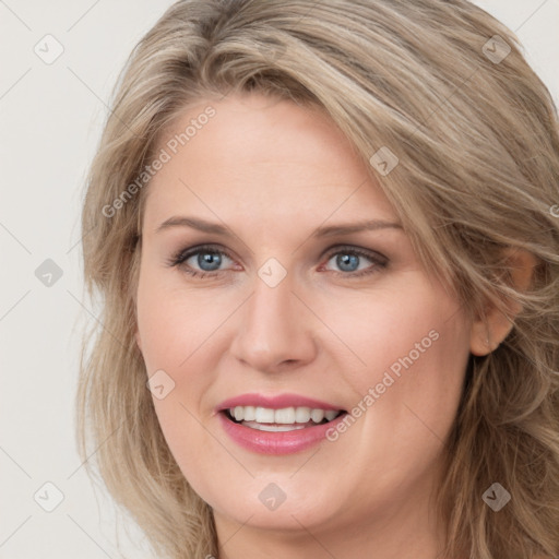 Joyful white young-adult female with long  brown hair and blue eyes