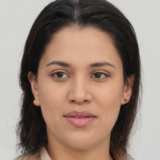 Joyful latino young-adult female with medium  brown hair and brown eyes