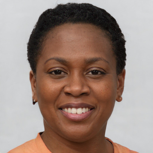 Joyful black young-adult female with short  brown hair and brown eyes