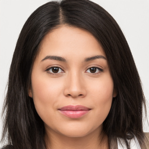 Joyful latino young-adult female with long  brown hair and brown eyes