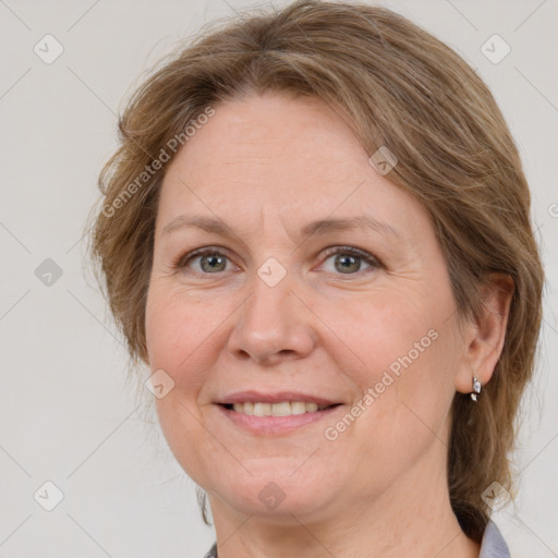 Joyful white adult female with medium  brown hair and grey eyes