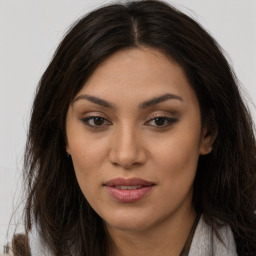 Joyful latino young-adult female with long  brown hair and brown eyes