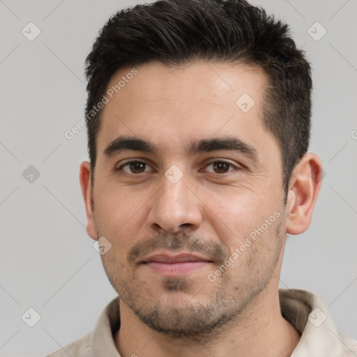 Joyful white young-adult male with short  black hair and brown eyes