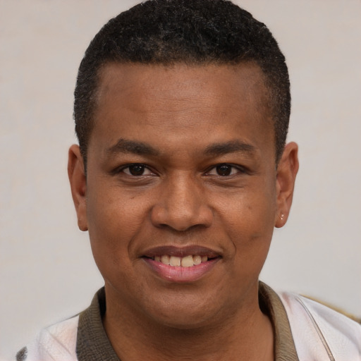 Joyful latino young-adult male with short  brown hair and brown eyes