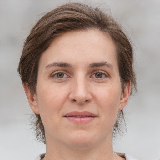 Joyful white adult female with medium  brown hair and grey eyes